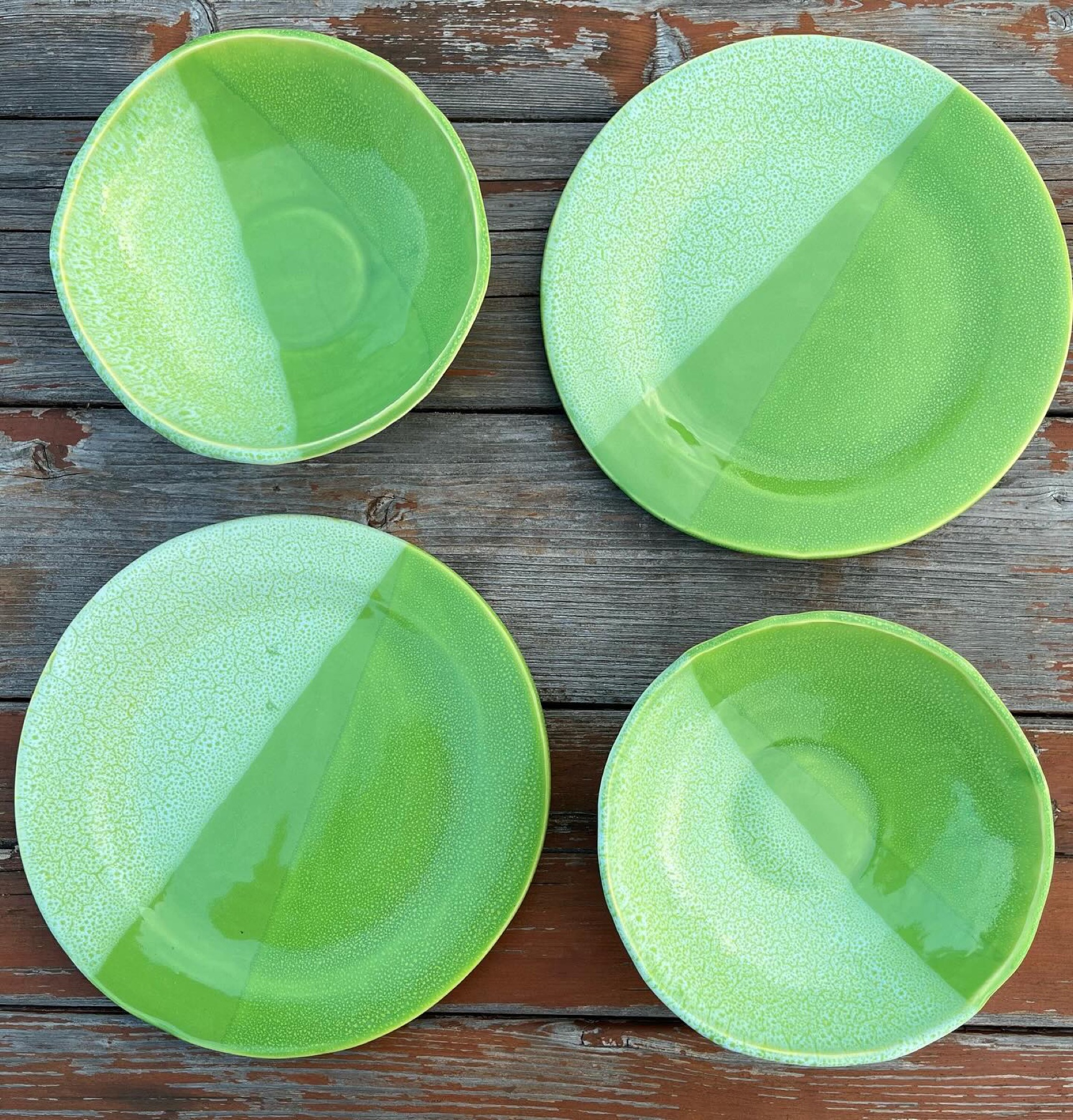 Four lime green handmade plates and bowls with split glaze details